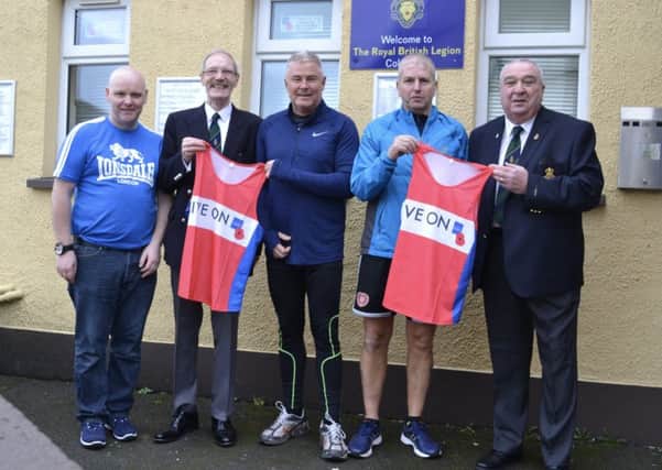 Colin Marchant and Michael Anderson receiving their Live On Poppy Appeal running vests from members of the Royal British Legion Coleraine. From left: Coleraine Branch Secretary Tommy Stirling, Bill Mills BEN Branch President, Colin Marchant, Michael Anderson  and Ronny Galbraith, Branch Chairman.