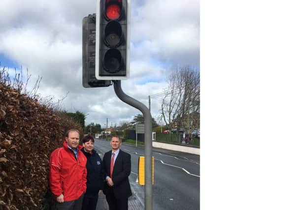 Alderman Wilson is pictured at the traffic lights on the Portadown Road with Principal of Tandragee Primary School David McCollam and the manager of Kids Academy Julieanne Guiney.