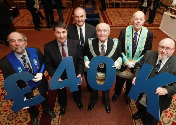 Pictured are some of the Freemasons from Carrick, (L-R Front Row) David Penpraze, Gareth Kirk, CEO Action Cancer, Provincial Grand Master, John Dickson and Hugh Blair. (L-R Back Row) Jim McCord and Patrick MacDonnel.