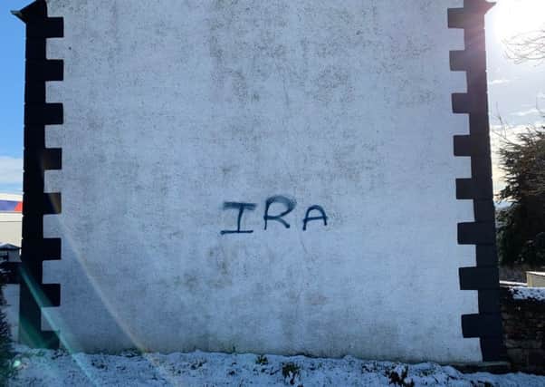 The letters 'IRA' were painted on the side of Claudy Orange Hall in what police are treating as a hate crime.