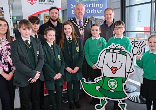 Chair of Mid Ulster District Council Sean McPeake launches the Irish language recycling guide with students from Gaelscoil Eoghain and Scoil Iósaef