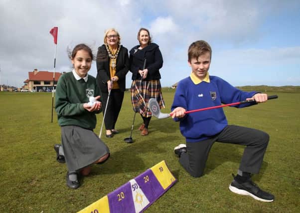 Amelia Michalska from St Patrick's Primary School Portrush and Paul Fletcher from Portrush Primary School are joined on Royal Portrush Golf Club green by Moira Doherty, Deputy Secretary, Department for Communities and Mayor of Causeway Coast and Glens Borough Council Brenda Chivers as they launch the Legacy Primary Schools Golf Programme ahead of this year's 148th Open