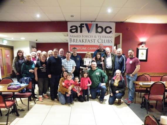 The Frontline Breakfast Club, Carrickfergus, proudly celebrated its first anniversary recently. Members were joined by Whitehead Royal British Legion, Tab4THEFALLEN11 and actorr and veteran supporter Charlie Lawson, who unveiled their new Armed Forces Veterans Breakfast Club banner.