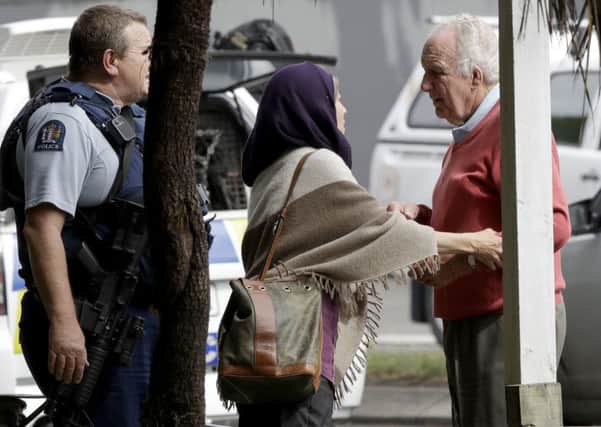 Police escort people away from outside a mosque in central Christchurch, New Zealand, Friday, March 15, 2019. Multiple people were killed in mass shootings at two mosques full of people attending Friday prayers, as New Zealand police warned people to stay indoors as they tried to determine if more than one gunman was involved. (AP Photo/Mark Baker)