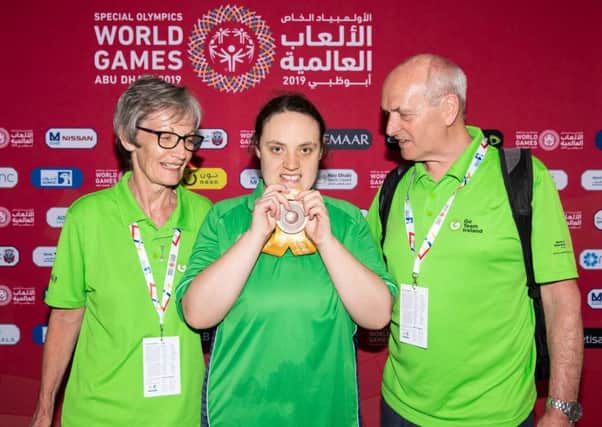 Emma Carlisle from Ballygowan won Bronze in the 100m backstroke, and was the firstIrish Athlete to get a medal. Emma is pictured with her Mum and Dad. Photo: Ricardo Guglielminotti /Special Olympics Ireland.