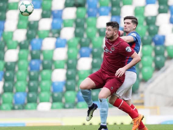 Institute striker Joe McCready shields the ball from Linfield's Jimmy Callacher during today's game at Windsor Park.
