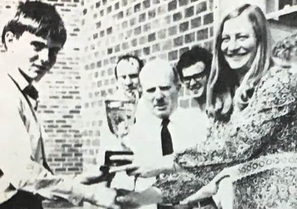 Matthew Shields receives the Victor Ludorum Cup for best athlete at Lisnagarvey High School in 1970 from Mary Peters