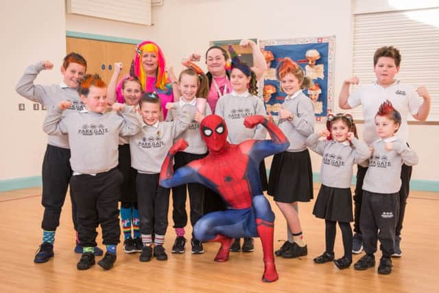 Asda Ballyclare Colleague, Adam Wallace as Spider man , Asda Ballyclare Community Champion, Claione Alderdice and Principal of Parkgate Primary, Mrs Peden, with pupils.