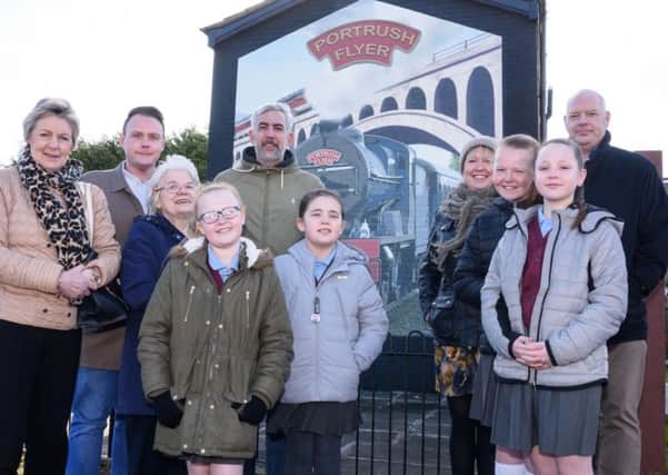 At the unveiling are Hollybank Primary School pupils, Tiarea, Alicia, Faith and Jasmin, with acting principal Lynsey Brett and school governor Vivian Robinson, Mark Cooper from the Monkstown Community Association, artist Dee Craig and John Reid from the Housing Executive