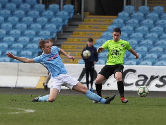 Ballymena United's Jonathan Addis tackles a Warrenpoint player