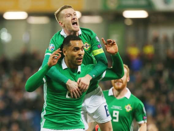 Northern Ireland captain Steven Davis celebrates with Josh Magennis, after the substitute fired home their late winner against Belarus.