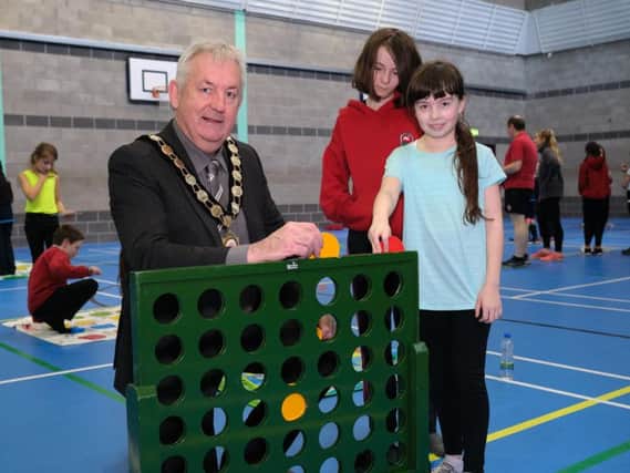 Chair of Mid Ulster District Council, Councillor Sean McPeake tests out the newly refurbished Maghera Leisure Centre Main Hall, along with local primary school children who were among the first to try the new facilities.