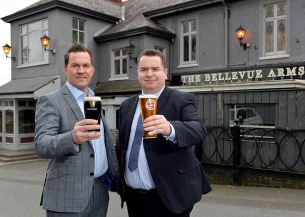 Andrew Gedge, left, is joined by Andy Tew, to toast the purchase of the iconic Bellevue Arms.