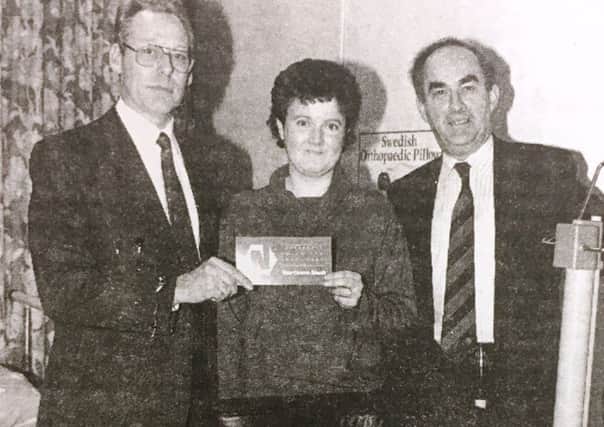 Pictured in 1993, Jim Stevenson, treasurer of the Northern Bank Employees charity committee presented RAMS physiotherapist Mandy Paul with a rehabilitation walked. Also included is Noel Beattie of the Northern Bank.