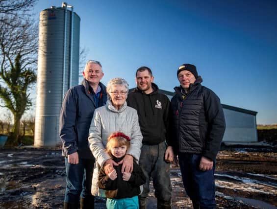 L-R) Stephen Comer, Senior Business Manager at First Trust Bank is pictured with four generations of the Allen family outside their new pig rearing unit. Tilly Allen, with her great granddaughter Lucy, her grandson David and son Robert.
