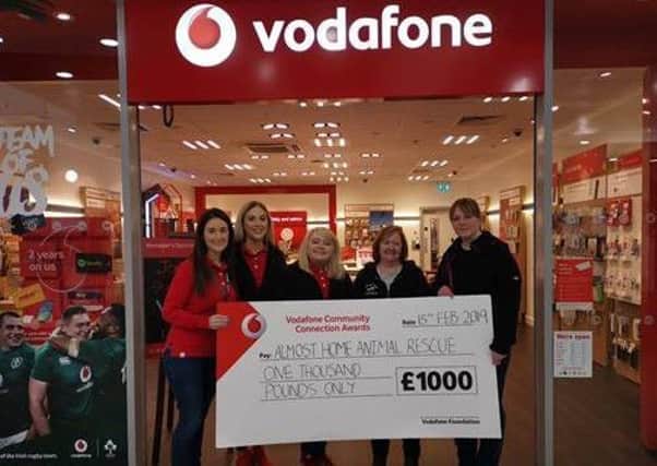 Vodafone staff present a cheque for £1,000 to Karen Matthews of Almost Home Animal Rescue.