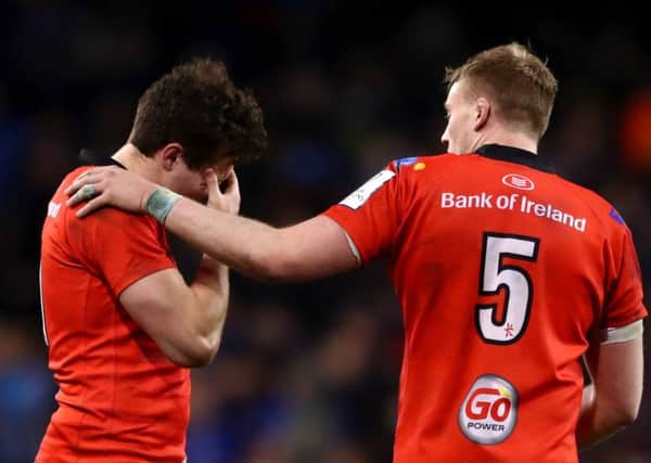 Kieran Treadwell  consoles team mate Jacob Stockdale after the Champions Cup Quarter Final match against Leinster