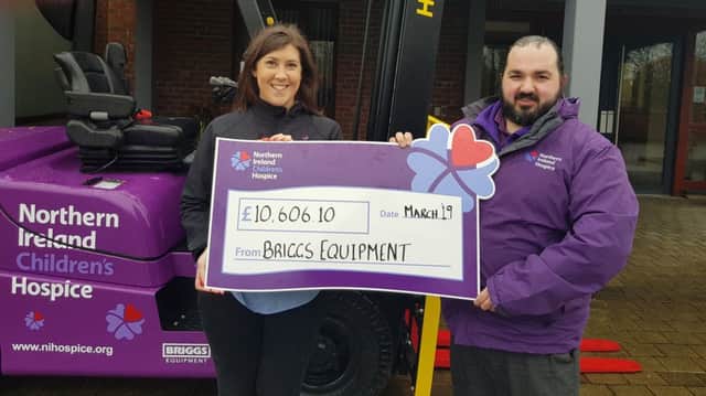 Ashleigh Hill, Briggs Equipment, and  Jonathan Lamberton, NI Childrens Hospice present Briggs Equipments 2018 fundraising total]