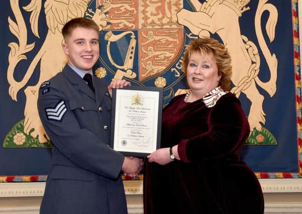 Mrs Fionnuala Jay-OBoyle, Her Majestys Lord Lieutenant for the County Borough of Belfast, presents Cadet Sergeant Ryan McDowell with the certificate which marks his latest achievement