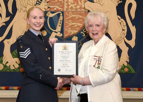 Cadet Sergeant Catherine Hill from Ballynure is pictured receiving the certificate which marks her honour from Mrs Joan Christie, Her Majestys Lord Lieutenant for the County of Antrim.