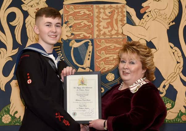 Able Cadet Bobby Seawright is pictured accepting his award certificate from Mrs Fionnuala Jay-OBoyle, Her Majestys Lord Lieutenant for the County Borough of Belfast.