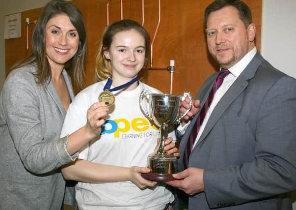 Abigail Reilly with Sarah Travers (left), MC of the Skillbuild NI competition, and Barry Nielson (right) Chief Executive of Construction Industry Training Board Northern Ireland