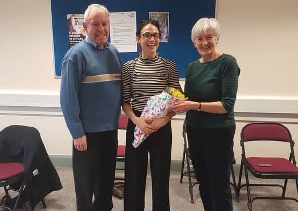 Chair of the Ballymena Branch of Parkinson's UK, James McClean, and Ballymena branch member Margaret Parkinson, present a gift to dance instructor, Charmaine McMeekin, who took a series of Movement to Music classes in Ballymena for people affected by Parkinsons.