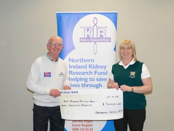Arlene Ferguson, Lady Captain of Greenacres Ladies' Golf Club presenting her charity cheque to John Brown, Chairman of NI Kidney Research Fund.