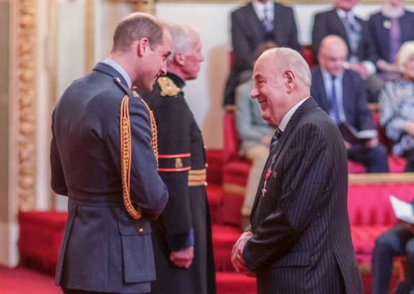 Andy Crawford receives his MBE from Prince William.