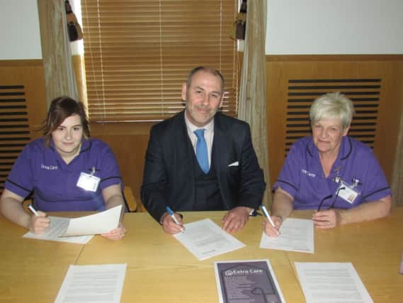 Brian Hutchinson, CEO Extra Care,  with care workers Sarah-Louise Connor (left) and Iris Connor.