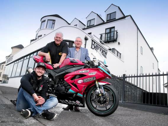 McAdoo Kawasaki Racing's Adam McLean with Armoy Clerk of the Course Bill Kennedy MBE, and Trevor Kane, owner of the Bayview Hotel in Portballintrae.