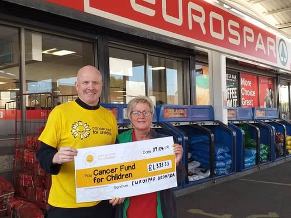 Leo Donaghy, Corporate Fundraiser at Cancer Fund for Children accepts a cheque for £1,333.33 from Irene Hunter from Eurospar Dromara