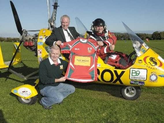 Norman Surplus  pictured with Larne RFC President Philip McMurtry and Paul Johnston following a previous flight.