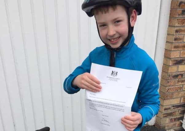 Joshua Bentley, eight, with the reply he received from Downing Street to his letter to the Prime Minister about making cycle helmets mandatory