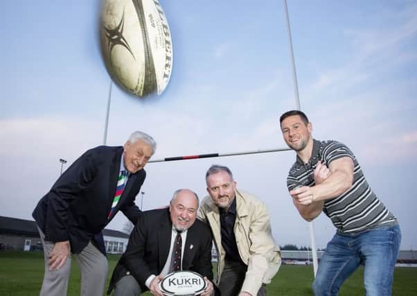 Former British and Irish Lion Willie John McBride and Ulster Rugbys John Cooney join William McKeown, president of Carrick RFC  and Richard Rogers, from the Alpha Programme, to celebrate the funding award.