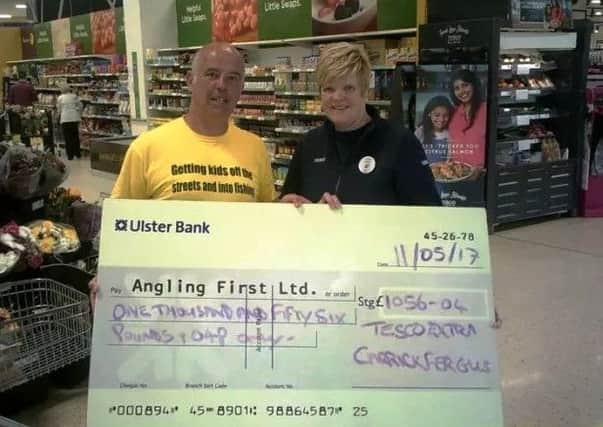 Mark McGivern, development officer for Angling First and Ann Ritchie, Community Champion for Tesco Extra Carrickfergus.