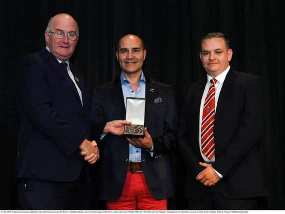 GAA President John Horan (left) presents Club Derry's Paul Lupari and Derry County PRO Conor Nicholl with the McNamee Award in Dublin on Saturday evening.