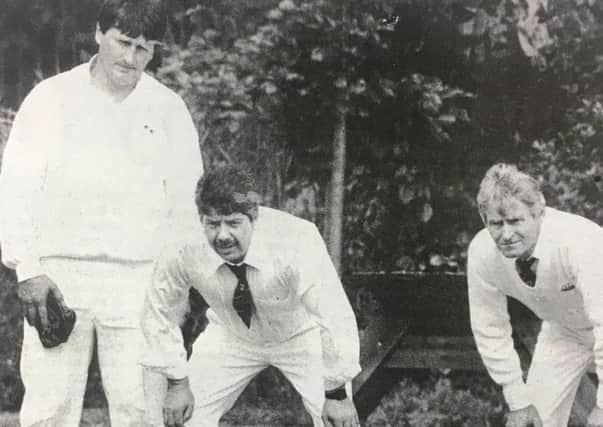Tony Bell, Malcolm Bell and David Armstrong assess the lie of the land during a bowls match in 1993