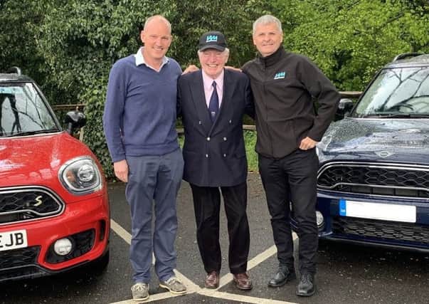 Race ace Paddy Hopkirk and his son Patrick with Richard Gladman (right) from IAM RoadSmart.