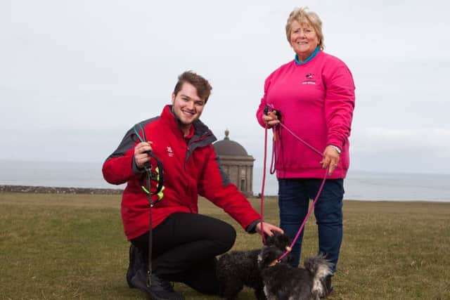 Chairman of Causeway Coast Dog Rescue charity Mrs Margaret Dimsdale-Bobby, with some of the rescue dogs, along with Andrew King of the National Trust, enjoying a leisurely walk at Mussenden Temple while raising awareness of the importance of having dogs on leads at this location.