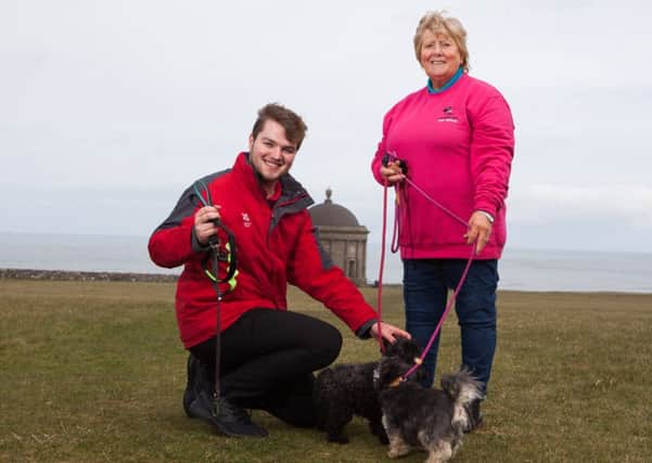 Chairman of Causeway Coast Dog Rescue charity Mrs Margaret Dimsdale-Bobby, with some of the rescue dogs, along with Andrew King of the National Trust, enjoying a leisurely walk at Mussenden Temple while raising awareness of the importance of having dogs on leads at this location.