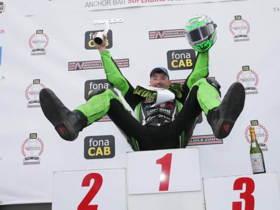 Glenn Irwin celebrates made it four Superbike victories in a row at the North West 200 on Saturday. Picture: Stephen Davison/Pacemaker Press.