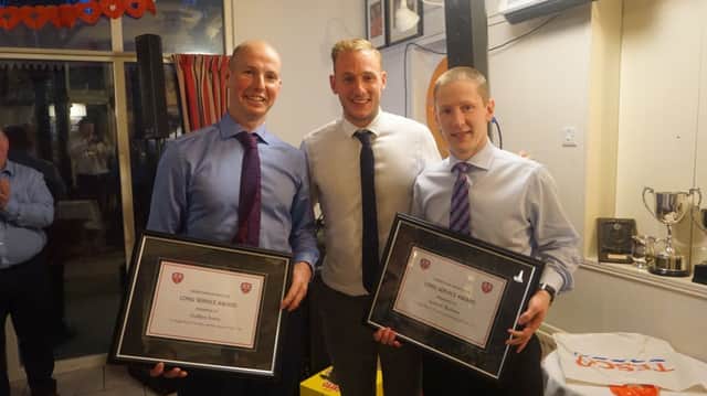 Godfrey Irwin (left) and Andrew Barbour are honoured by the club with a commemoration of special long service to Cookstown Hockey Club after 25 years playing for the First XI. They are pictured with David Ames