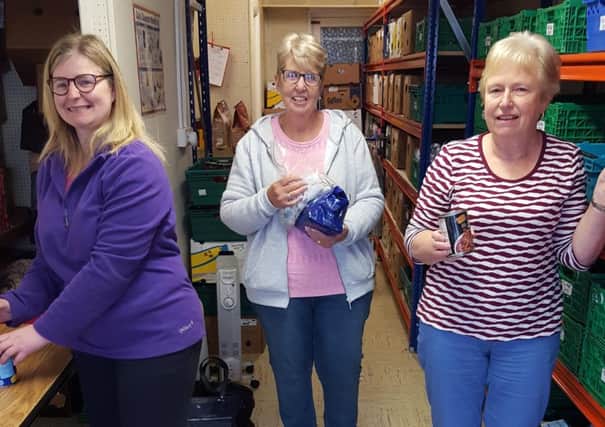 Stephanie Tyndall and Doreen Crymble from Carnmoney Church at work in the warehouse with  (centre) Norma McIlveen from Abbey Presbyterian.