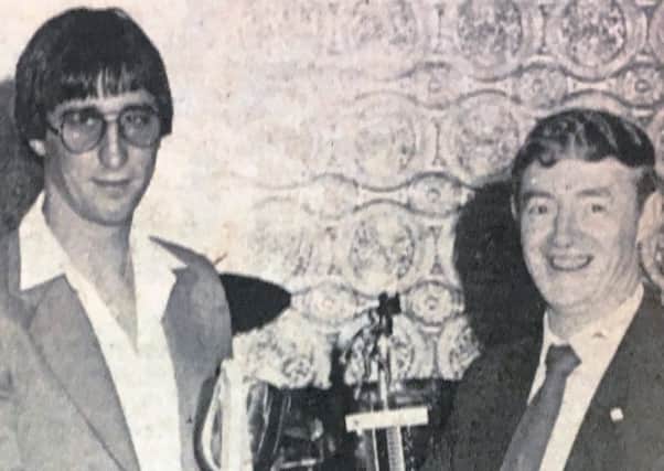 Mr D McGreavey presents leading goalscorer G Murphy with a trophy in 1980