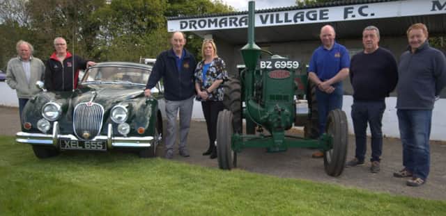 Dromara Vintage and Classic Club chairman Brian McGrillen (centre) with Gillian Owens treasurer of Dromara Village FC and members of the Vintage Club with two of the exhibits which will be on show this year