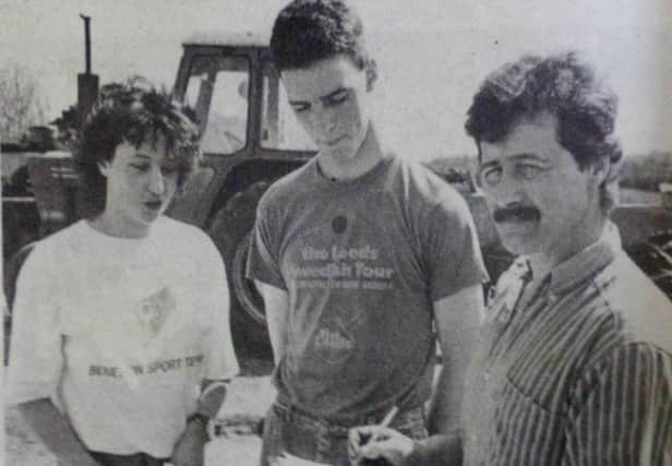 Tommy Gilmour (centre) who was competing in the tractor driving section of the YFC events with Robert Wright and Michelle Price. 1989