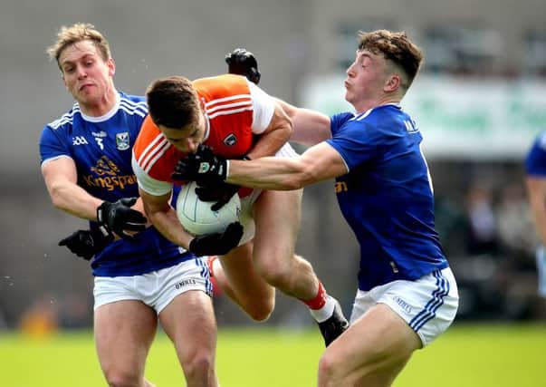 Armagh's Niall Grimley with Padraig Faulkner and Conor Brady of Cavan