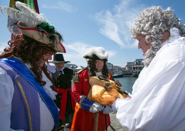 King Billy is welcomed ashore during a previous re-enactment.