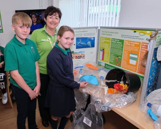 Eoin and Savannah view the ReCycling display